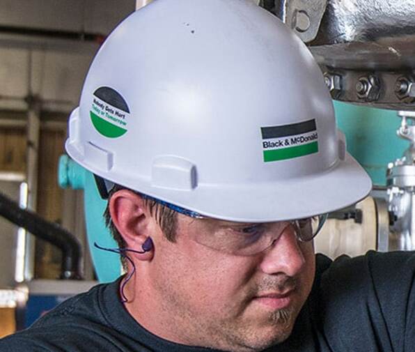 Construction worker wearing a white hard hat.